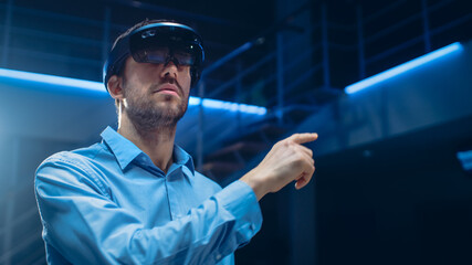 Aufkleber - In 3D Content Creating Laboratory Engineer Wearing Professional Virtual Reality Headset Works and Gestures in Augmented Reality. Stylish Low Angle Portrait Shot 