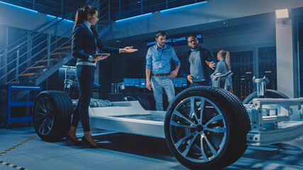 Wall Mural - International Team of Automobile Design Engineers Talking and Designing Autonomous Electric Car. Vehicle Platform Chassis Has Wheels, Engines, Battery. Evolution of Clean Renewable Energy Efficiency