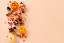 Autumn Composition With Orange Pumpkin ,pine Cones, Cinnamon Sticks, Berries And Small Gifts. Flat Lay, Top View.秋の背景　オレンジかぼちゃとプレゼント
