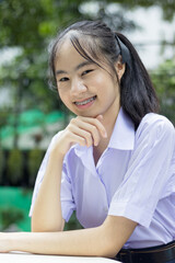 portrait young girl in Thai high school smiling happily.