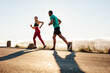 © Jacob Lund - Fitness couple running on road