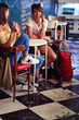 © luckybusiness - Young female tourists enjoying in a cafe