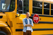 © Angelov - Smiling bus driver looking at camera outside the elementary school
