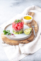 Wall Mural - Tuna tartare tartar with avocado and quinoa. gourmet presentation with culinary ring on wite plate