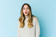 © Asier - Young caucasian woman isolated on blue background being shocked because of something she has seen.