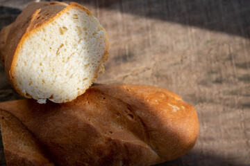 Fresh bread on a rough wooden table. Food background.