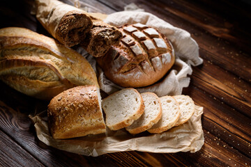 Various freshly baked breads on a wooden rustic table