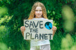 © Natallia - child girl activist with save the planet poster in forest park. preteen kid volunteer fight against pollution, Global Warming, recycle garbage. Ecology environmental problem