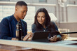 © SuperStock - Portrait of young people working on a tablet at an outdoor cafe.