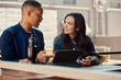 © SuperStock - Portrait of young people working on a tablet at an outdoor cafe.