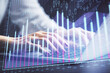 © peshkova - Double exposure of businesswoman hands typing on computer and forex chart hologram drawing. Financial analysis concept.