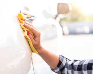 Wall Mural - Girl polishing car door, close up