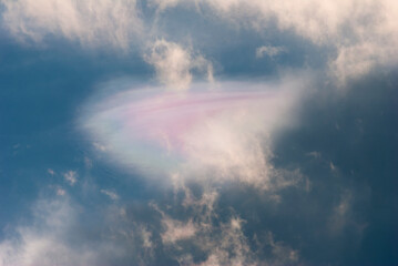 Multicolored cloud in blue sky, natural light decay.