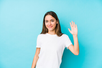 Wall Mural - Young caucasian woman  isolated smiling cheerful showing number five with fingers.