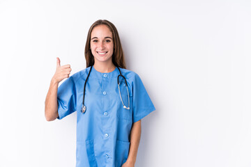 Wall Mural - Young nurse woman isolated smiling and raising thumb up