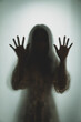 Leinwandbild Motiv Ghost concept shadow of a women behind the matte glass blurry hand and body soft focus