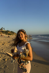 Poster - Shallow focus shot of a young caucasian female posing at camera near the ocean