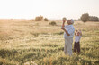© Maria - Happy senior man Grandfather with cute little boy grandson playing in field. Happy child with Grandfather playing outdoors