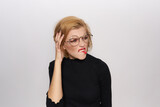 Fototapeta Konie - Cute blonde in glasses bright makeup black jacket cropped view light background emotions