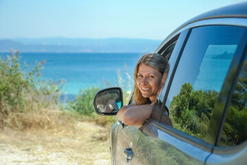 Wall Mural - happy girl from car at sea greece background