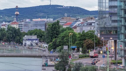 Wall Mural - Aerial view along the Danube Canal in Vienna night to day transition timelapse before sunrise in the summer. People walking on waterfront