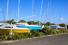 A Row Of Small Yachts, Stored Out Of The Water In A Marina's Garden