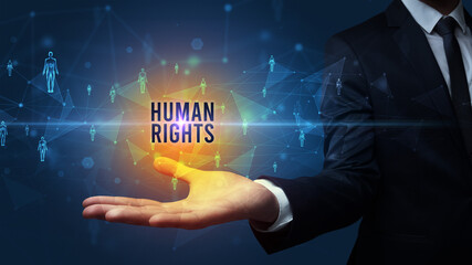 Elegant hand holding HUMAN RIGHTS inscription, social networking concept