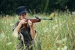 © SHOTPRIME STUDIO - Woman soldier With a weapon in cover, a black cap hunting weapons green