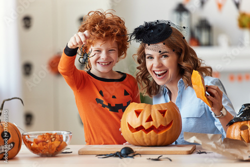 Cuadros en Lienzo happy family mother and son laughing and making scary faces during Halloween celebration