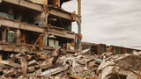 Fototapeta Niebo - Remains of destroyed industrial building with internal communications. Demolition of building on territory plant. Background with dilapidated building and fragments of bricks and construction debris