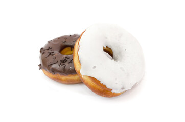 Two delicious donuts with black and white chocolate icing isolated on a white background.