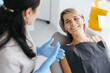 © diignat - Female Dentist examine and discussing with happy patient about treatment
