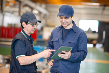 Workers using a tablet in a modern factory