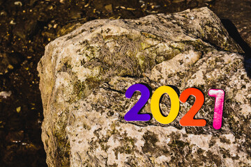 numbers of different colors new year 2021 on a stone 