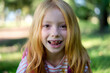 Cute redhead girl shows her tooth