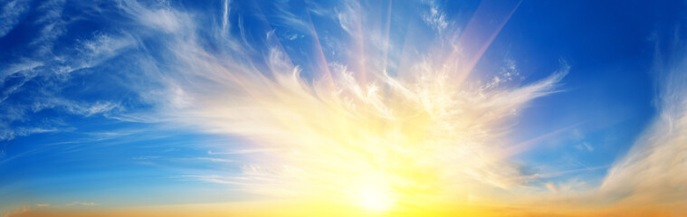 Wall Mural - panorama of sunset dramatic sky with bright sun
