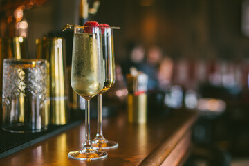 prosecco glasses for two standing on a bar stand