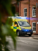 British Ambulance, Parked At The Side Of The Road During The Day - Lights Flashing