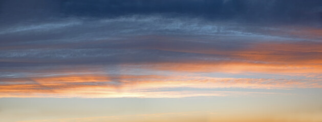 Wall Mural - sky panorama with gray and orange clouds, above blue sky