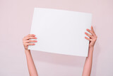 Fototapeta Mapy - hands hold a white sheet for your inscription on a white background