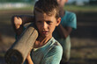 © Wavebreak Media - Boys carrying log at boot camp