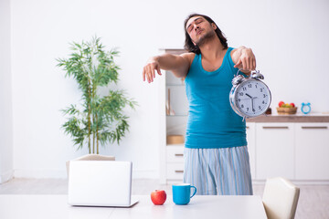 Wall Mural - Young man waking up at home