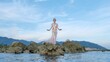 © Glebstock - Fairy woman posing at sea rocky shore