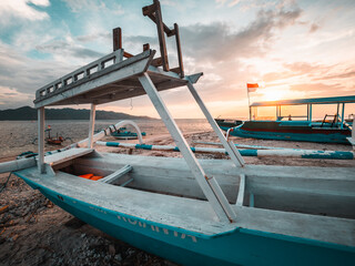 Wall Mural - Indonesian fishing boats on the beach at sunset, Gili Islands, Gili Trawangan
