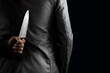 businessman hide knife behind back
