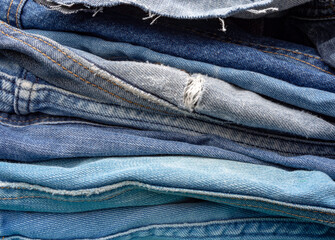 A pile of old blue jeans ready to be recycled in the circular economy. 