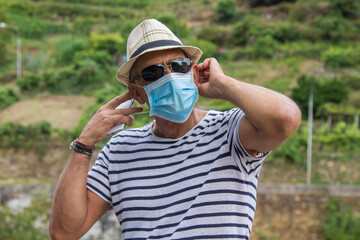 Wall Mural - man with medical mask using medical phone