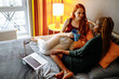© yurakrasil - cheerful afro and european lesbian women at home on the bed