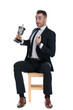 © Viorel Sima - Proud businessman holding trophy and pointing to himself