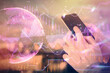 © peshkova - Double exposure of man's hands holding and using a digital device and forex graph drawing. Financial market concept.